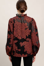 A jacquard woven top featuring ruffled neckline with front tie, button down and long sleeve