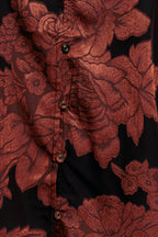 A jacquard woven top featuring ruffled neckline with front tie, button down and long sleeve