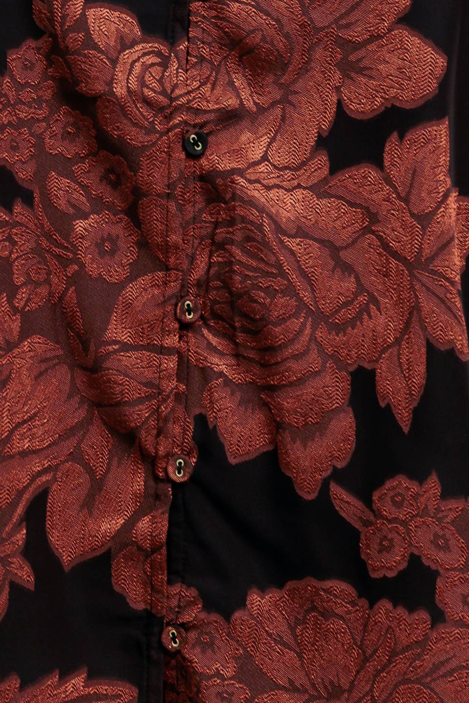 A jacquard woven top featuring ruffled neckline with front tie, button down and long sleeve
