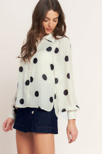 A Black/Ivory polka dot printed woven top featuring collar, button down, long sleeve with cuff and cami.