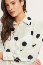 A Black/Ivory polka dot printed woven top featuring collar, button down, long sleeve with cuff and cami.